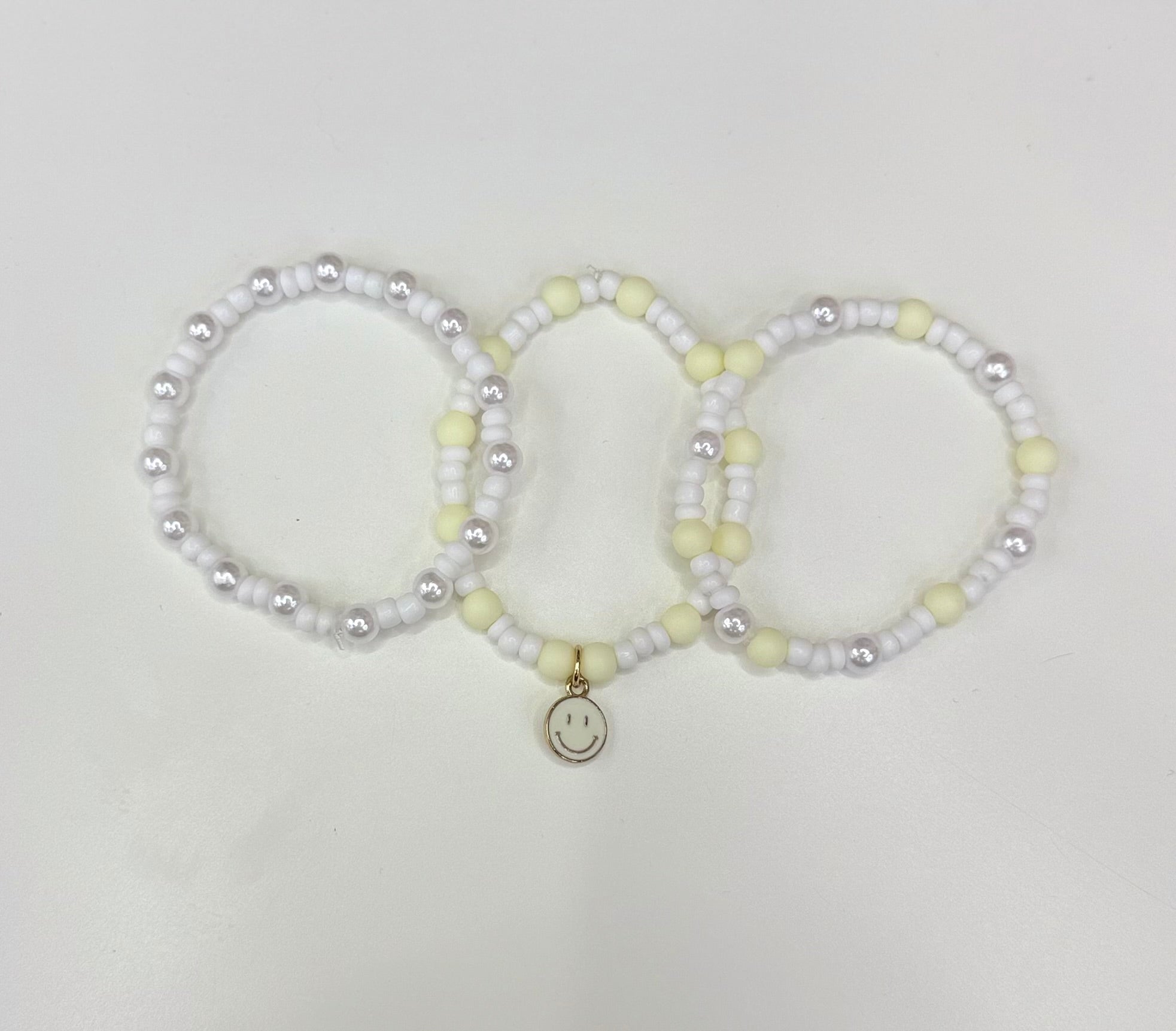 White smiley bracelet stack (3)